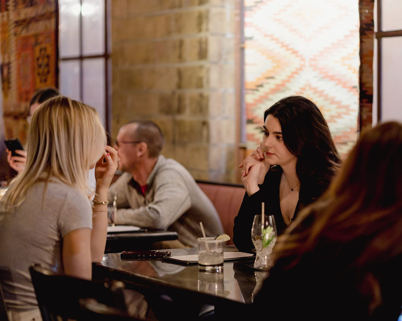 Guests enjoying cocktails and conversation at Myrtle’s speakeasy lounge