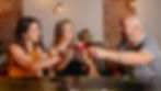 Group of friends toasting cocktails at a private dining event inside Myrtle’s Fur Vault & Bar in downtown Sioux Falls