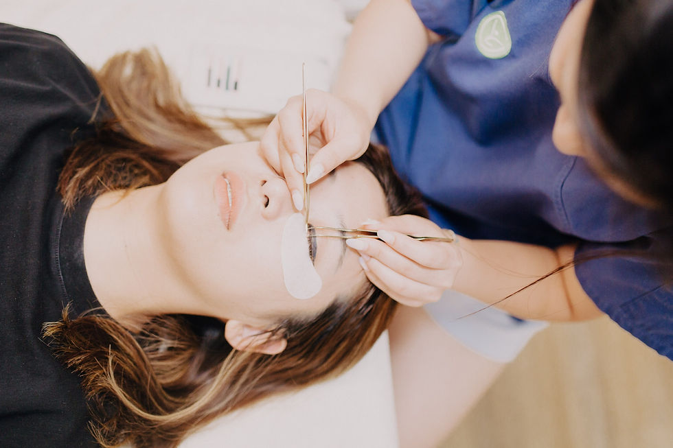 Lash technician applying eyelash extensions on a customer