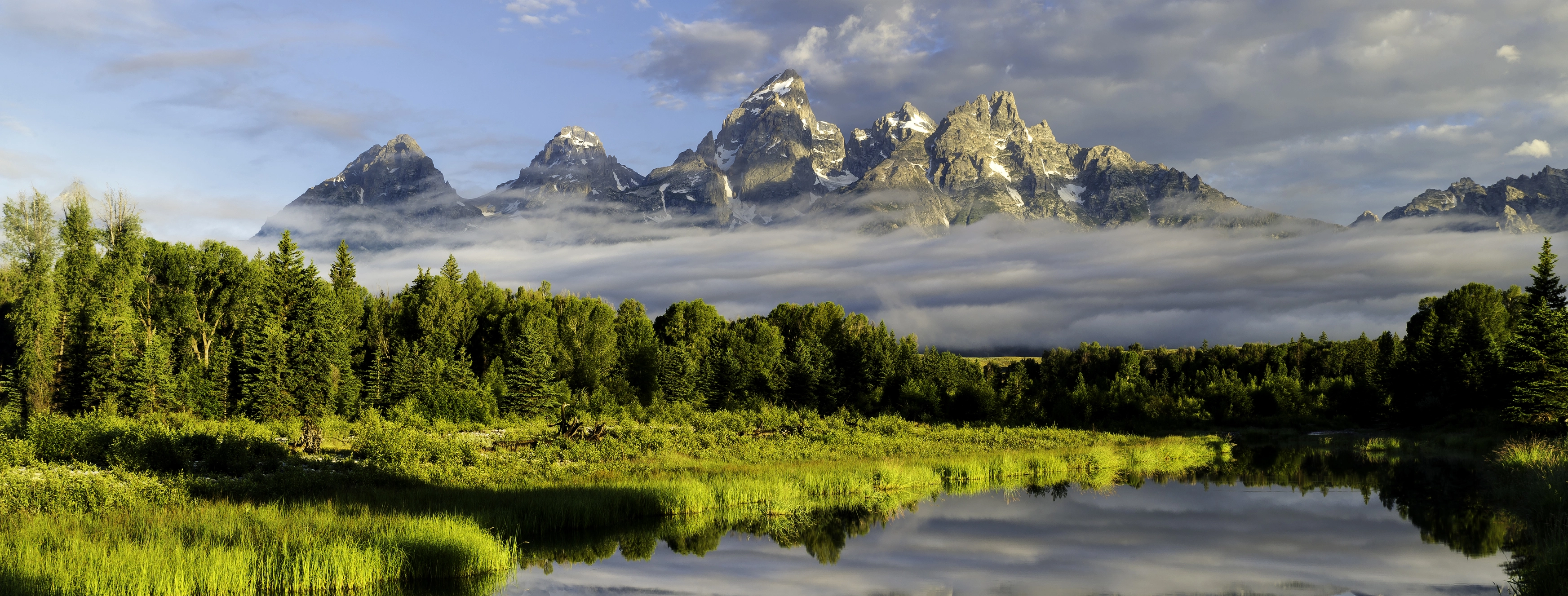 a lake surrounded by trees and mountains