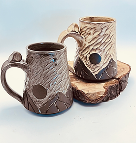 Hand-carved stoneware Vista mug with mountain landscape.