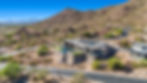 A Modern custom home nestled on a hillside with a desert mountain view
