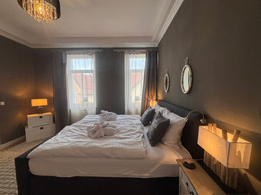 Doppelbett des Schlafzimmers bei Tag mit angeschalteten Lampen