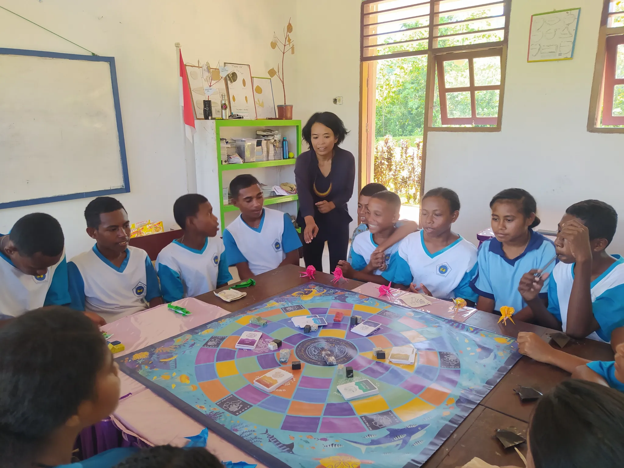 children play tabletop Operation Ocean in a classroom in Papua