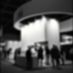 seeling at an exhibition booth blqck american.jpg