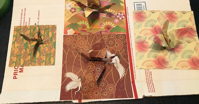 a collection of origami cranes on top of a paper