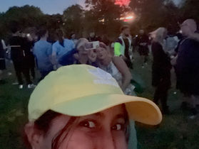 A girl in a yellow hat with fireworks