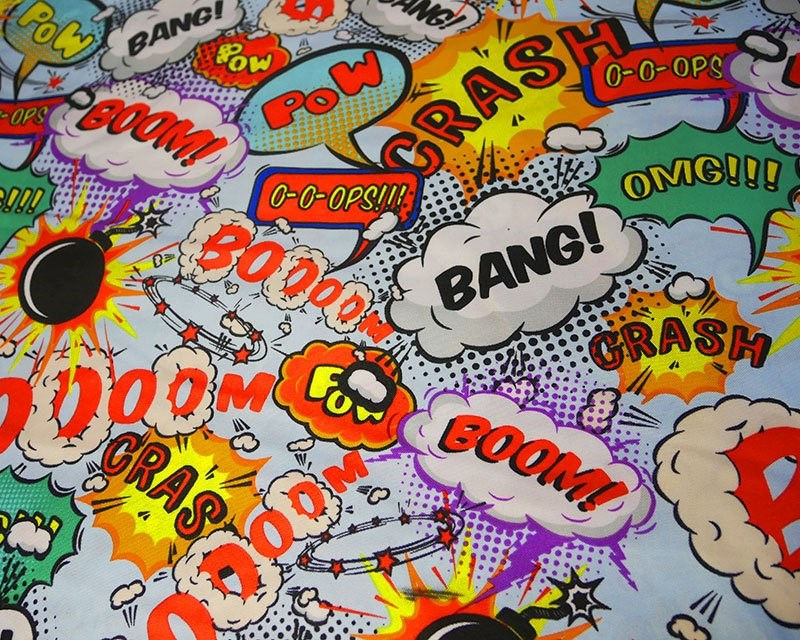 Miniaturebillede: Boom, Pow, Bang Polyester Fabric on Sky Blue Background - Dressmaking Material 