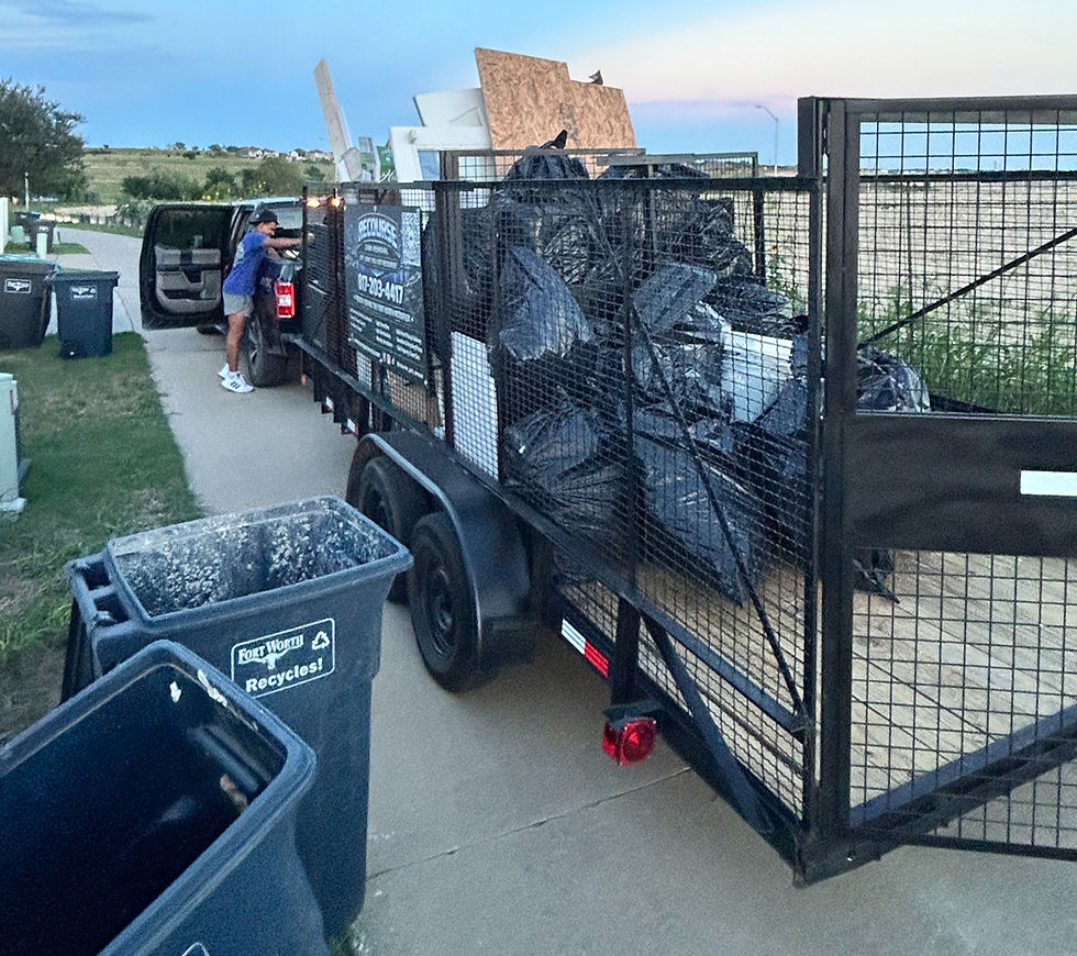 Wide angle view of a junk removal team loading a truck with furniture and boxes