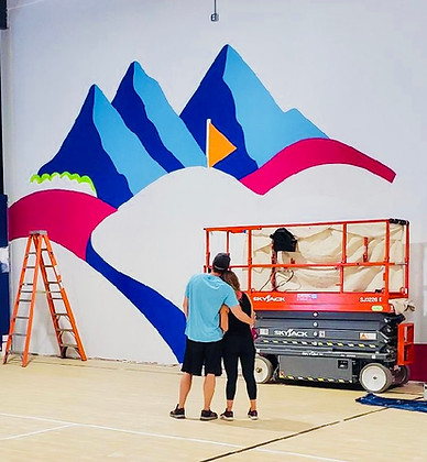 Kassidy and Matthew looking at wall mural in Club
