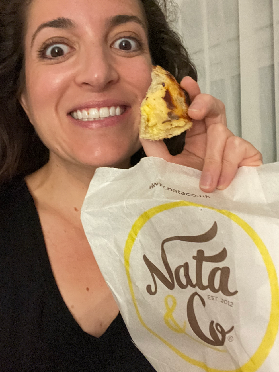 Lisa with a pastel de nata, which is a portuguese dessert