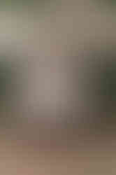 Groom sitting on a garden bench laughing before the ceremony, a candid pre wedding moment that highlights the value of hiring a wedding videographer in Calgary.