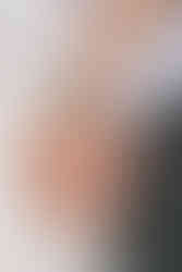 Meaningful elopement ideas detail shot of wedding rings on clasped hands with a blue floral cuff bracelet