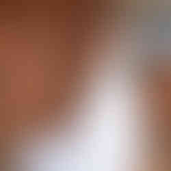Bride and groom hug tightly outside a rustic wood wall during first look wedding photos on their wedding day.
