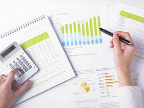 Small business owner reviewing bookkeeping reports and business expenses
