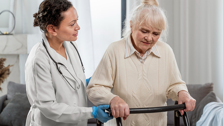 care giver helping elderly woman