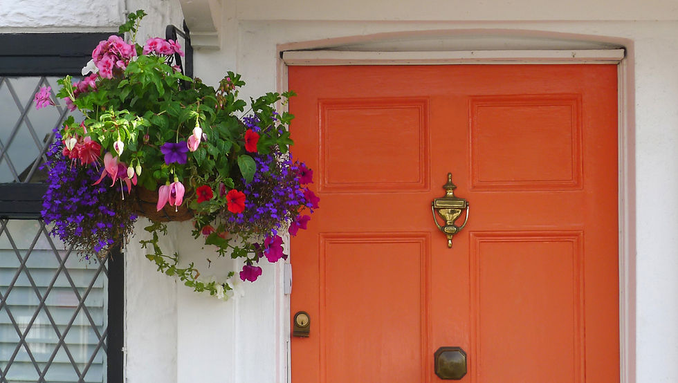 handing basket outside an orange front door to illustrate kerb appeal
