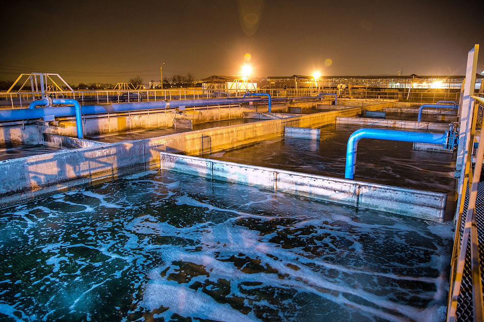 Modern wastewater treatment plant of chemical factory at night. Water purification tanks.j