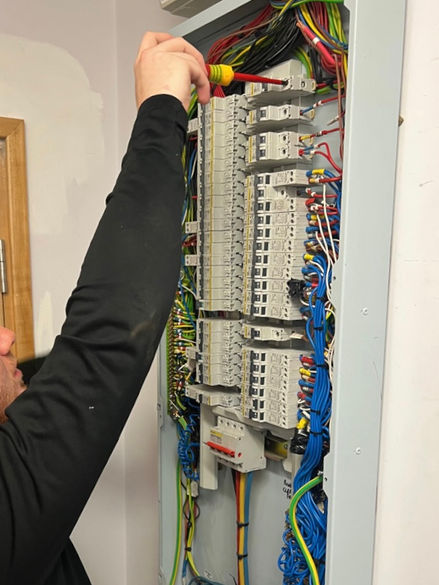 Electrician working on wiring for a commercial building.