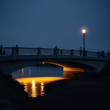 a bridge with light and water underneath - perhaps a bench and lamp post .jpg