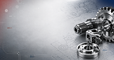 Precision metal components, gears, and engineered parts on technical drawings representing metal stamping, toolmaking, CNC milling, and precision manufacturing services.