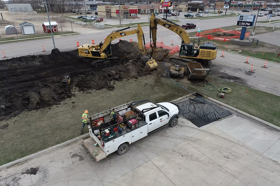 Excavators and a service truck working on a construction site