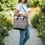 Thumbnail: Woman carrying a patterned tote bag, wearing white top and denim jeans.