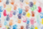 White wall with colorful multicolored hand prints. Friendship concept background. Children