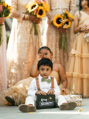 Cute ring bearer with “Ring Security” box during wedding ceremony captured by Valentino Films