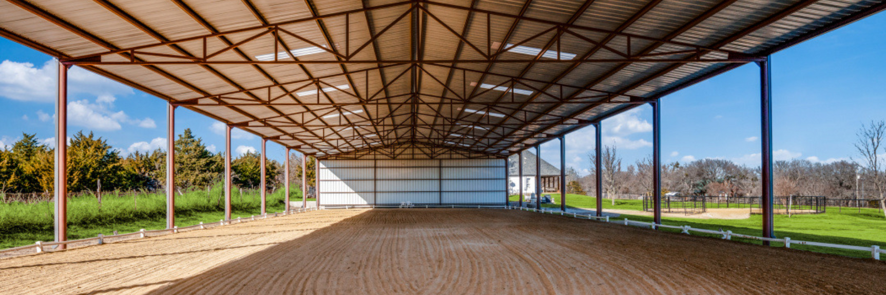 covered arena, green space, horseback riding
