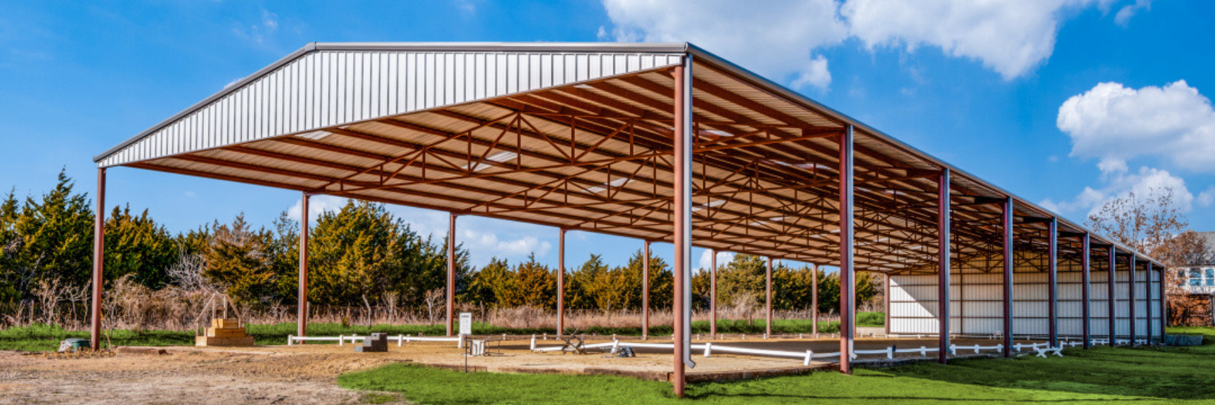 covered arena, green space, horseback riding