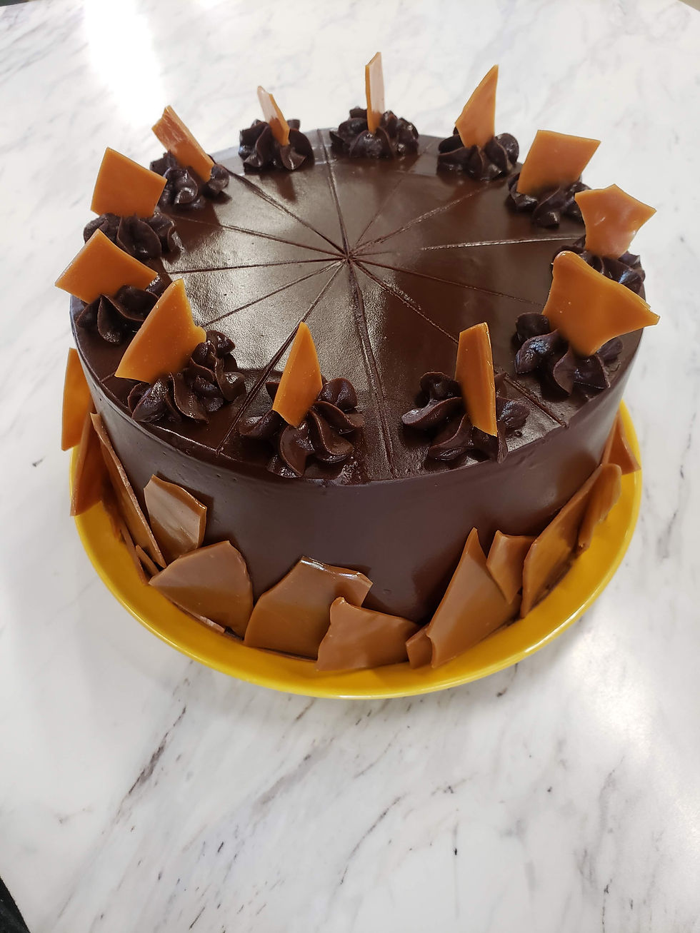 Chocolate cake, salted caramel, chocolate ganache, and toffee pieces