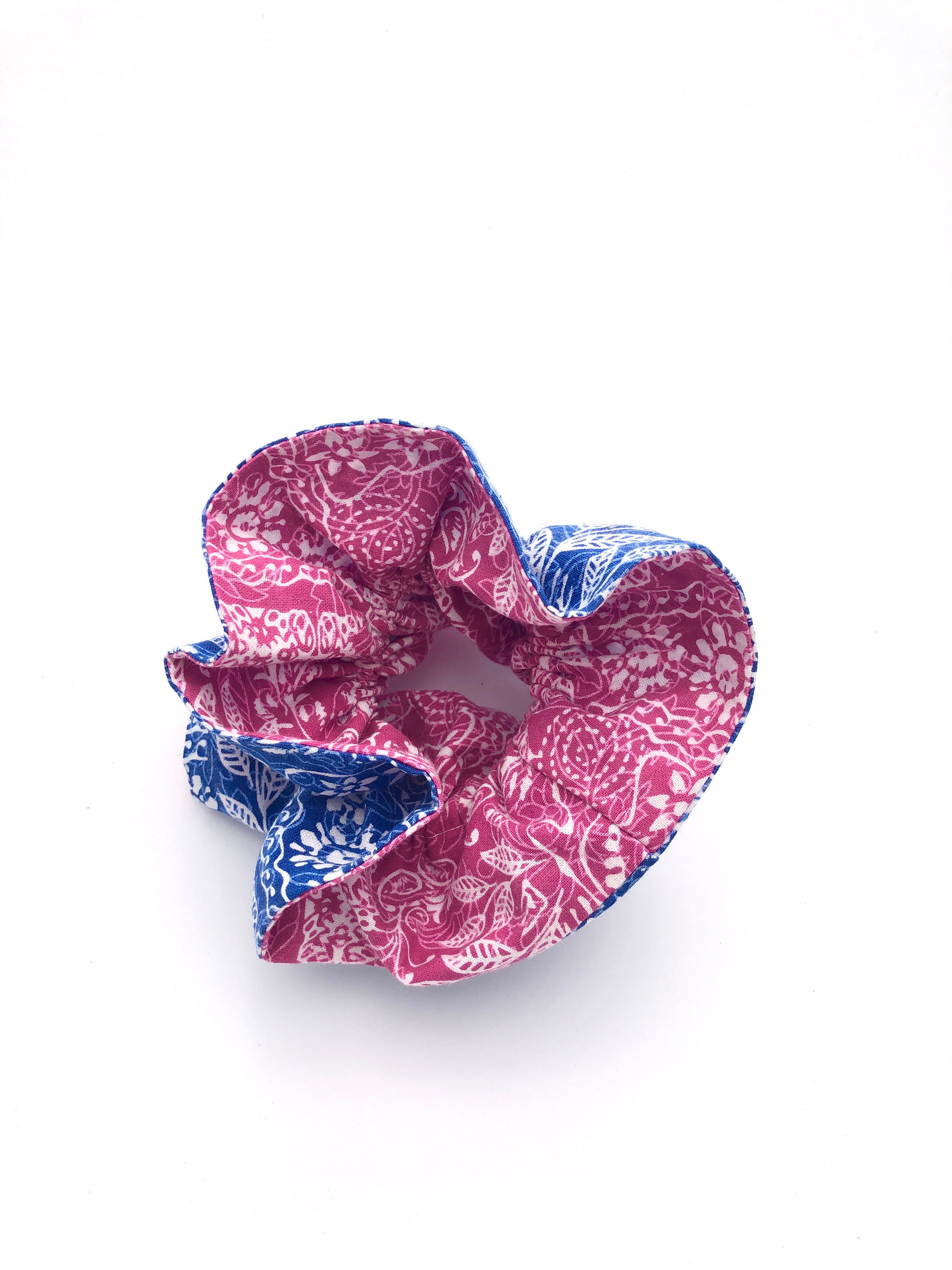 Reversible scrunchie with a mix of blue and pink and white and pink patterned fabric