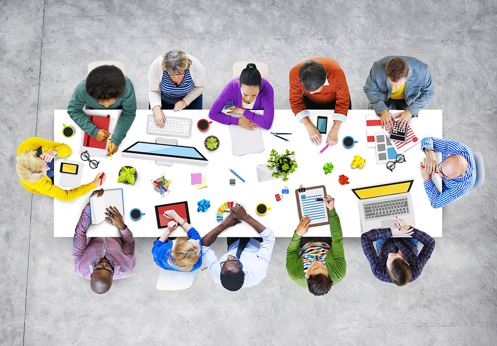 looking down on desk with people working