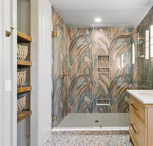 Luxury shower featuring botanical pattern mosaic tile accent wall in Palmetto Dunes master bath.