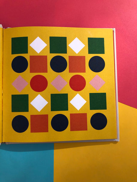 Coloured geometric shapes on a bright yellow background