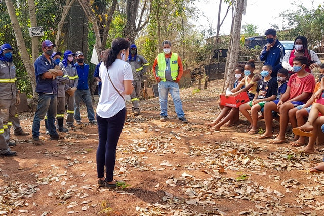 multiple people are shown, all wearing masks, many of which are youth