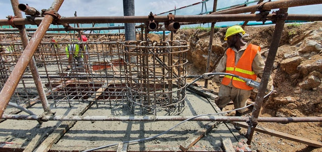 A worker carefully prepares the Temple’s foundation.