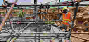 A worker carefully prepares the Temple’s foundation.