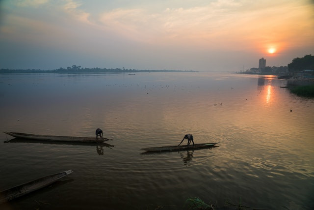 an image of two people on top of small canoes