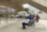 an image is shown of people praying together