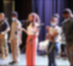 people standing on a stage singing