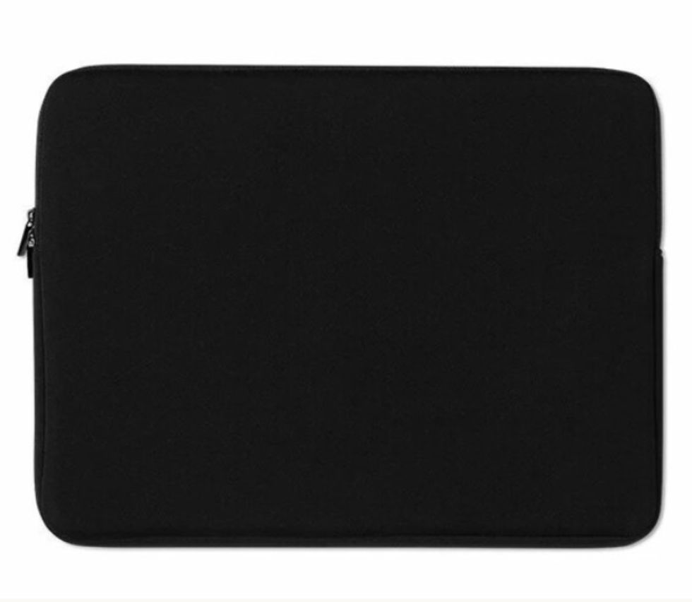 Thumbnail: the black back side of a laptop sleeve on a brown wooden desk.
