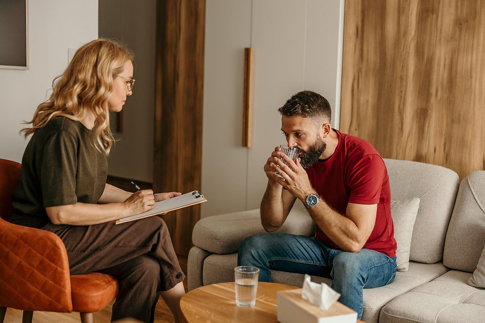 Male client speaking with a therapist during an individual counselling session