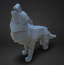 Gray low poly wolf figurine in a howling pose on a dark studio background.