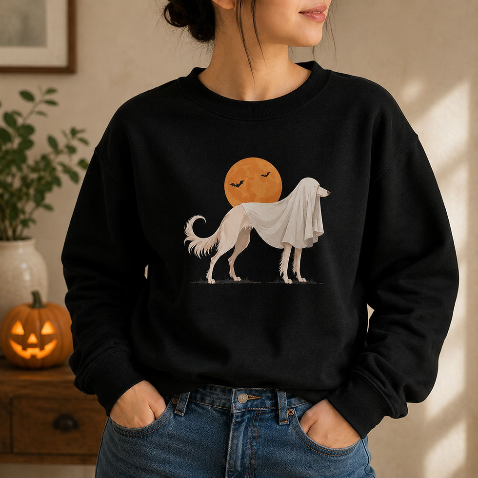 Woman wearing the black Saluki Haunting sweatshirt featuring a ghost-draped Saluki beneath an orange moon.