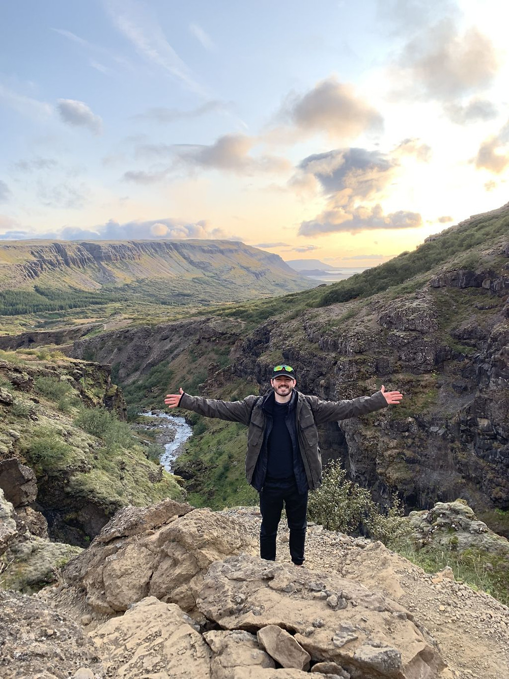 young tourist hiking to glymur waterfall