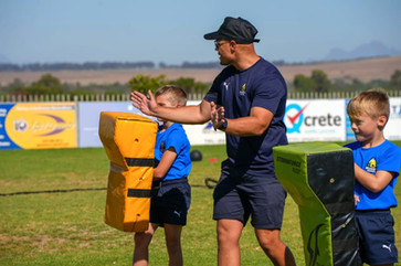 Rugby Coach at rugby Champs training camp Training the kids 