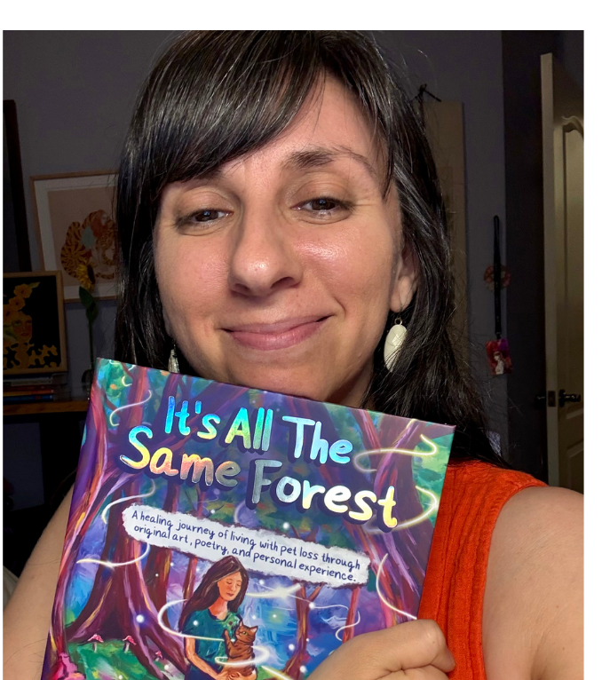 Paige Rechtman in orange top holds book It’s All The Same Forest, with colorful cover and subtitle about healing pet loss through art and poetry
