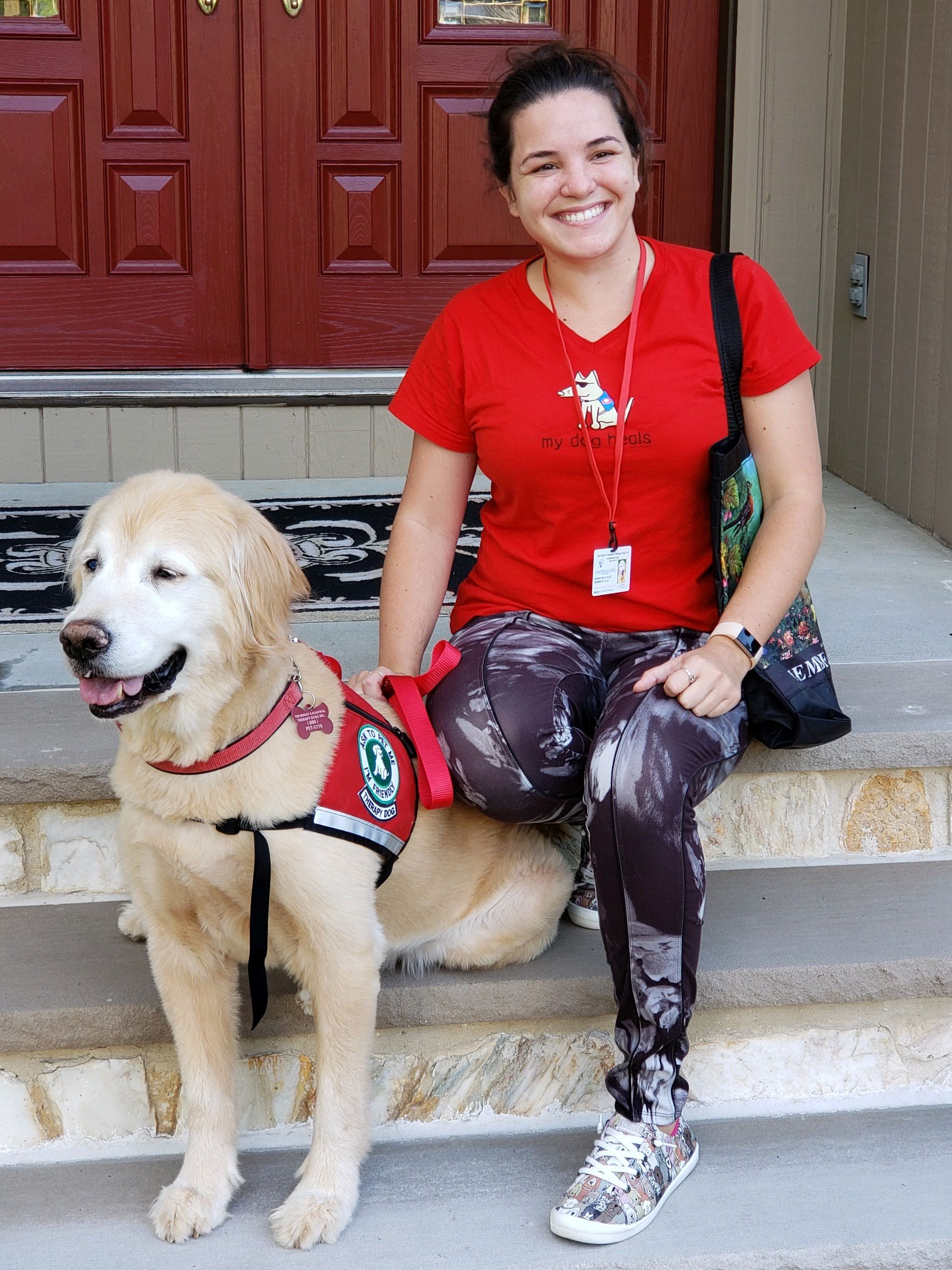 Christina Pellegrino smiling for a portrait with her therapy dog Buster